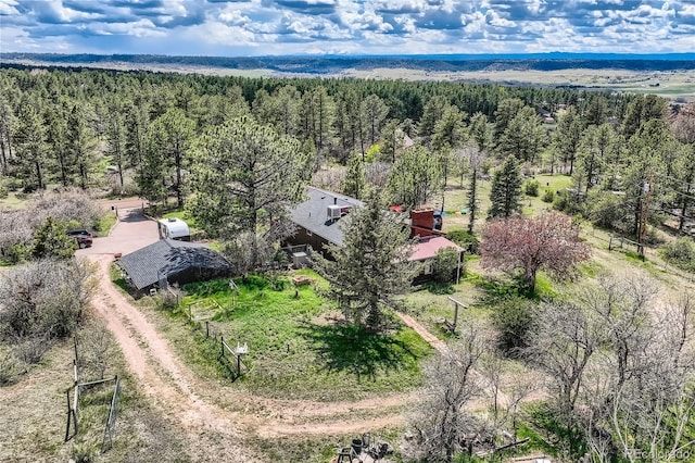 aerial view of property and surrounding area with a heavily wooded area