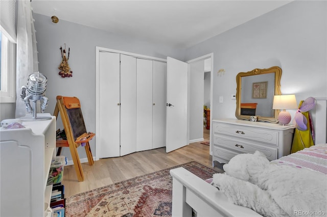 32187 Sylvan Rd, Golden, CO 80403 - bedroom with light wood-style flooring, a closet, and baseboards