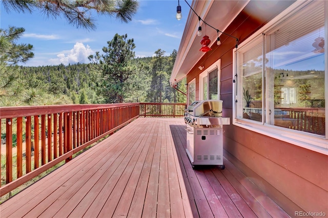 32187 Sylvan Rd, Golden, CO 80403 - wooden deck with a wooded view and area for grilling