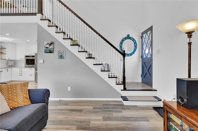 32187 Sylvan Rd, Golden, CO 80403 - foyer featuring light wood finished floors, stairs, recessed lighting, and a towering ceiling