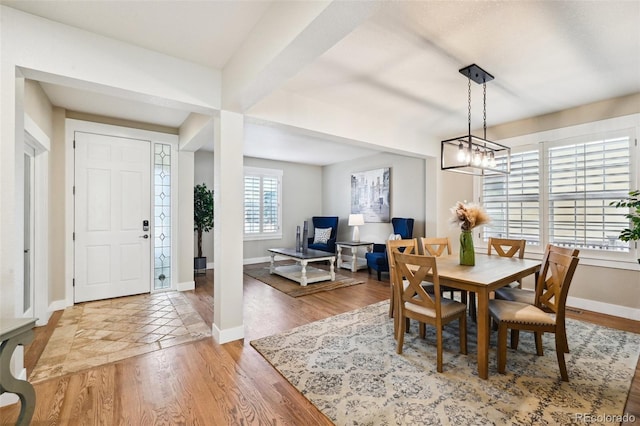 dining space with an inviting chandelier and hardwood / wood-style floors