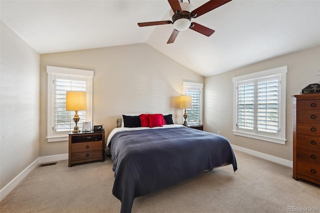 bedroom featuring multiple windows, lofted ceiling, light carpet, and ceiling fan