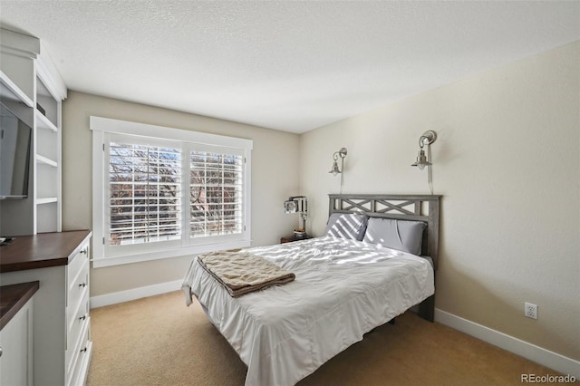 bedroom with light colored carpet and a textured ceiling