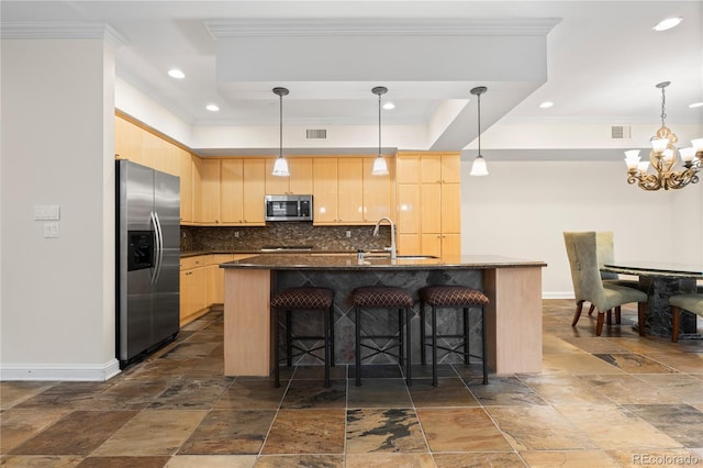 kitchen featuring tasteful backsplash, appliances with stainless steel finishes, sink, light brown cabinets, and a kitchen island with sink