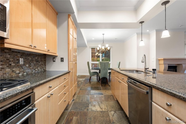 kitchen featuring light brown cabinets, backsplash, stainless steel appliances, sink, and decorative light fixtures