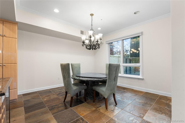 dining area featuring ornamental molding and a chandelier