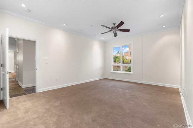 carpeted empty room with crown molding and ceiling fan