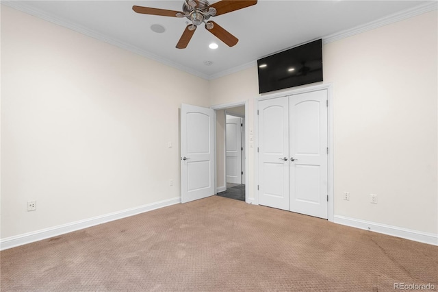 unfurnished bedroom with ornamental molding, carpet floors, and ceiling fan