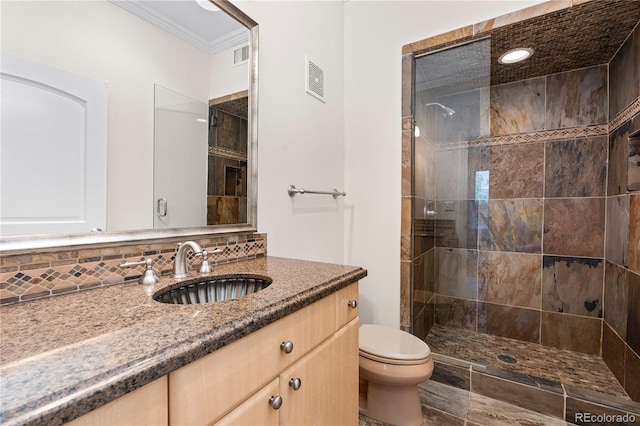 bathroom with toilet, a shower with shower door, crown molding, vanity, and tasteful backsplash