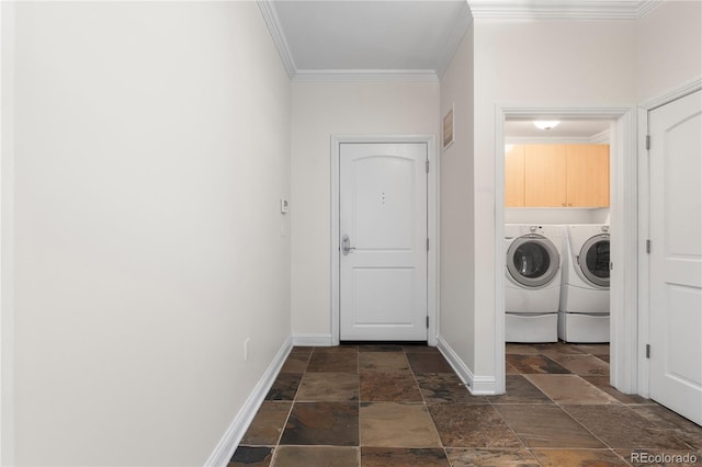 laundry area featuring cabinets, ornamental molding, and washer and clothes dryer