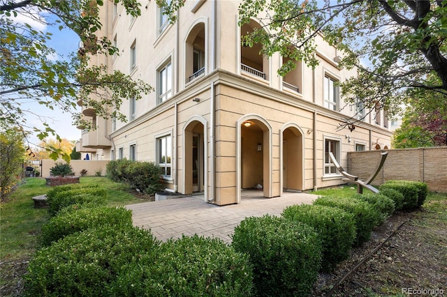 rear view of house with a balcony and a patio