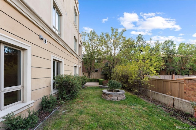 view of yard with a fire pit