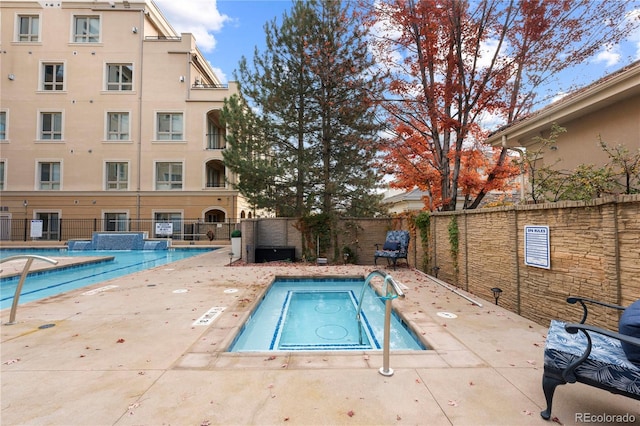 view of pool featuring a hot tub and a patio area