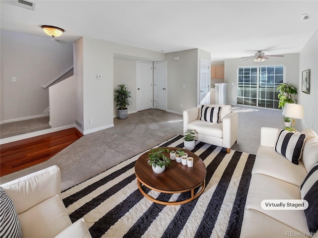 living room featuring carpet floors and ceiling fan