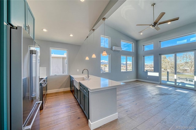 kitchen featuring kitchen peninsula, plenty of natural light, stainless steel appliances, and light hardwood / wood-style floors