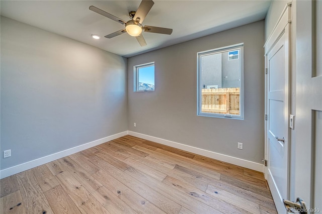 spare room featuring light hardwood / wood-style floors and ceiling fan