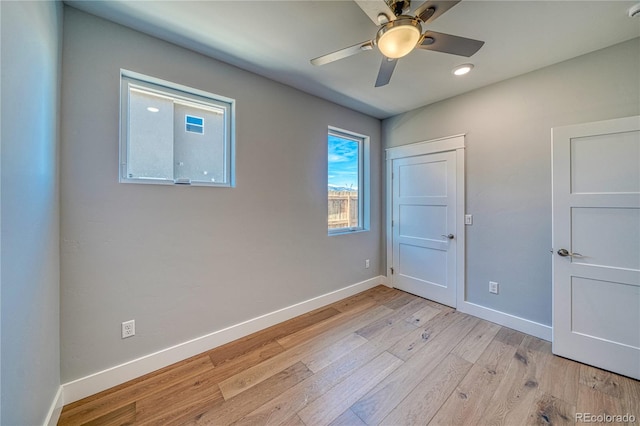 unfurnished room with light hardwood / wood-style flooring and ceiling fan