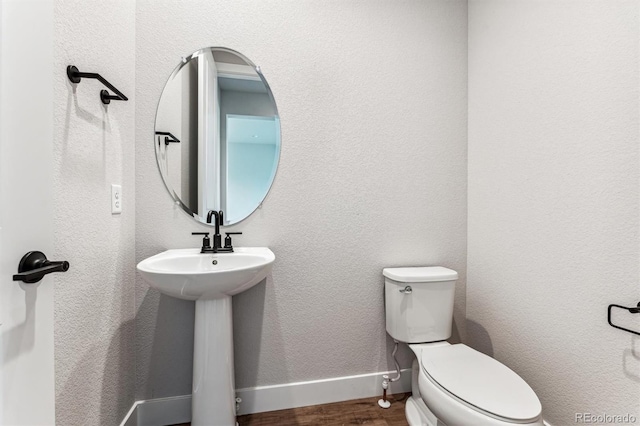 bathroom featuring toilet and hardwood / wood-style flooring