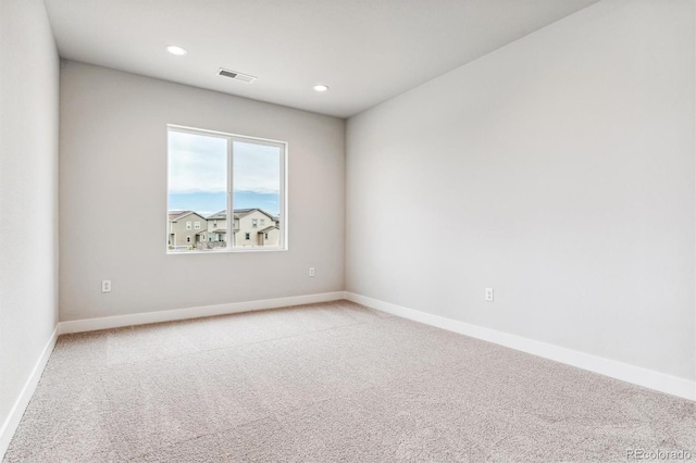 unfurnished room with light colored carpet