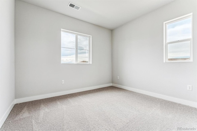 spare room with carpet flooring and a healthy amount of sunlight