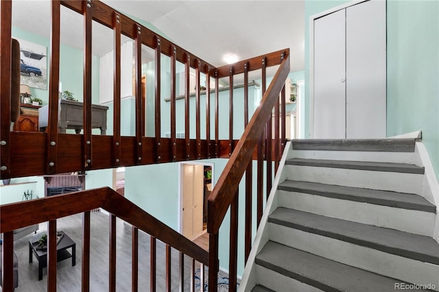 stairs featuring wood finished floors