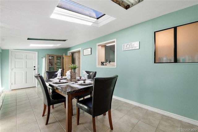 dining space with light tile patterned flooring and baseboards