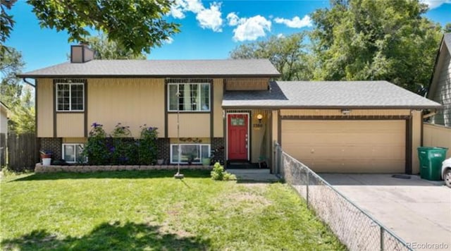 split level home featuring an attached garage, concrete driveway, and brick siding