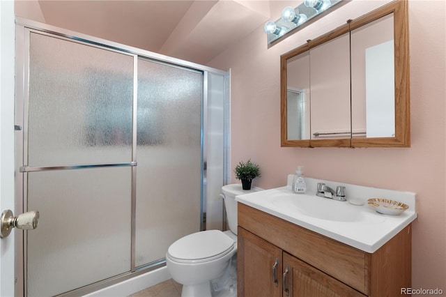 full bathroom with a shower stall, toilet, and vanity