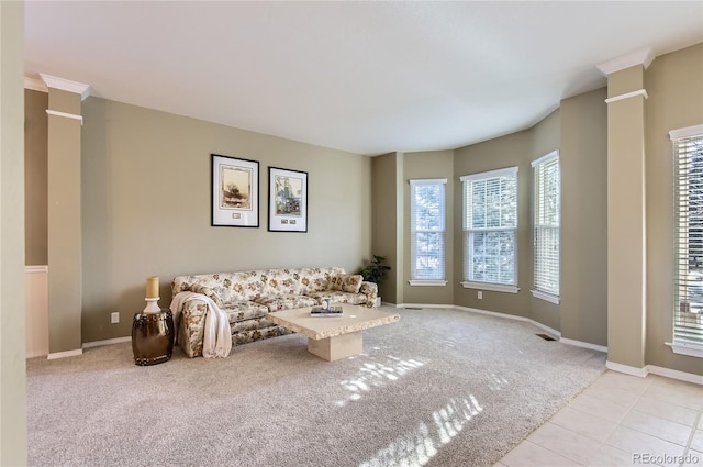 living room with decorative columns and light colored carpet