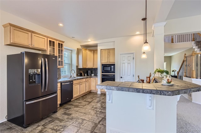 kitchen with tile countertops, kitchen peninsula, a breakfast bar area, hanging light fixtures, and black appliances