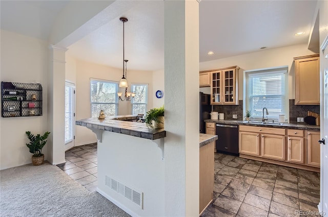 kitchen with backsplash, a kitchen breakfast bar, dishwasher, pendant lighting, and sink