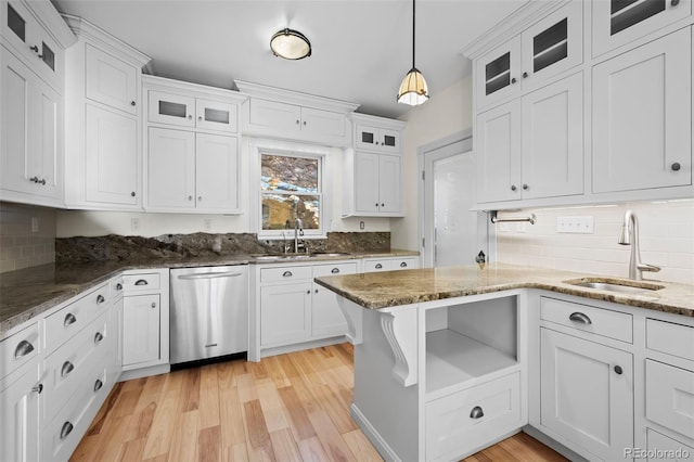 kitchen featuring stainless steel dishwasher, pendant lighting, white cabinets, and sink