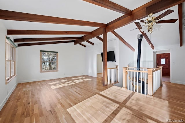 unfurnished living room featuring ceiling fan, light hardwood / wood-style flooring, and lofted ceiling with beams