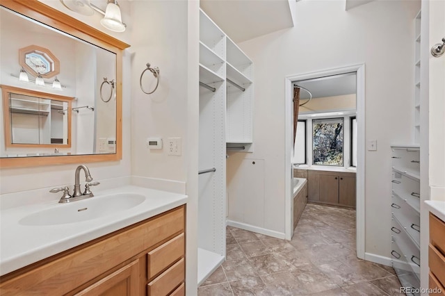 bathroom with vanity and a tub to relax in