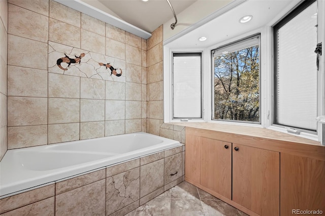 bathroom featuring tiled bath