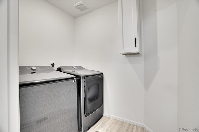 10124 Xanadu St, Commerce City, CO 80022 - laundry room featuring baseboards, visible vents, wood tiled floor, cabinet space, and washing machine and clothes dryer