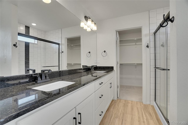 10124 Xanadu St, Commerce City, CO 80022 - bathroom with double vanity, a sink, and a stall shower