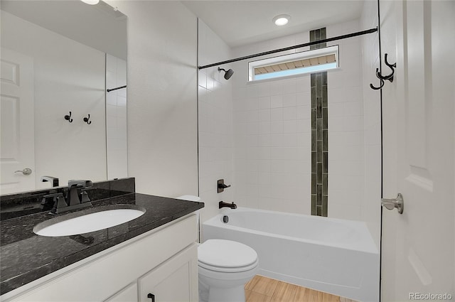 10124 Xanadu St, Commerce City, CO 80022 - bathroom with toilet, wood finished floors, vanity, and shower / tub combination