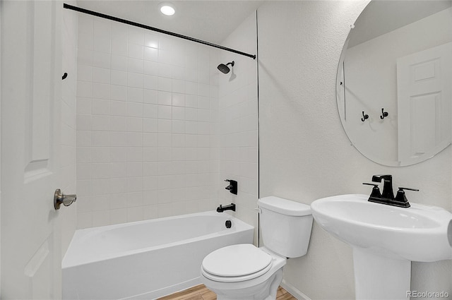 10124 Xanadu St, Commerce City, CO 80022 - full bathroom featuring baseboards, a sink, toilet, shower / bathing tub combination, and wood finished floors