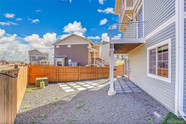 10124 Xanadu St, Commerce City, CO 80022 - view of yard featuring a fenced backyard, a residential view, a patio area, and a balcony