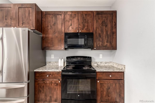 329 S 3rd Ave, Deer Trail, CO 80105 - kitchen featuring black appliances, light stone countertops, and dark brown cabinetry