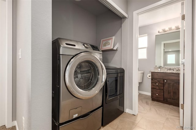 329 S 3rd Ave, Deer Trail, CO 80105 - laundry room featuring washing machine and dryer and baseboards