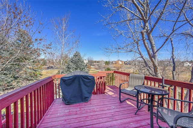 wooden deck with a grill