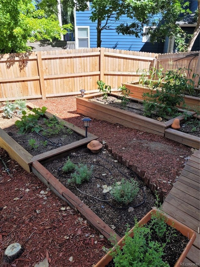 view of yard featuring a vegetable garden and fence