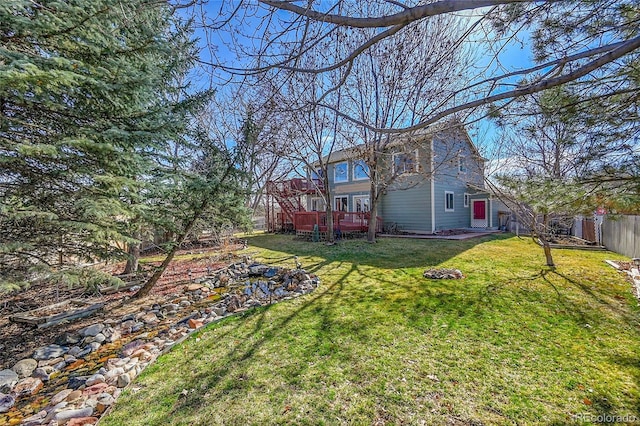 view of yard featuring a deck and fence