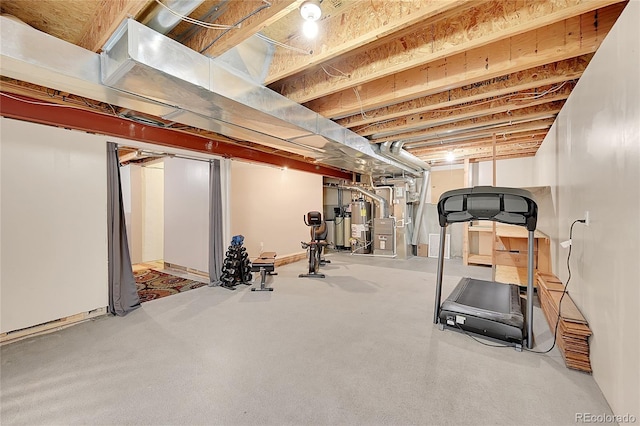 exercise room with carpet flooring, gas water heater, and heating unit