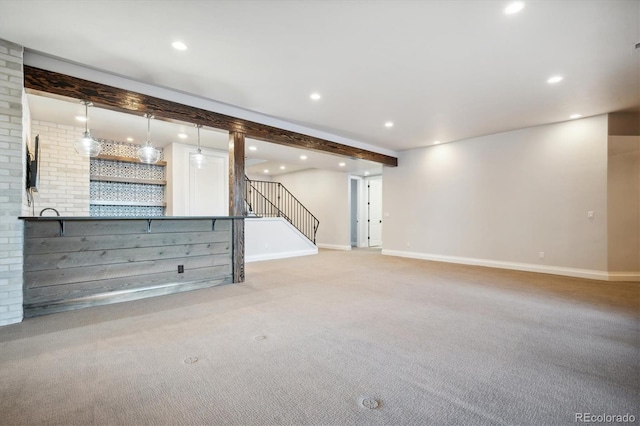 basement featuring light carpet and bar area