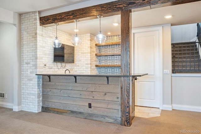 bar with hanging light fixtures and light carpet