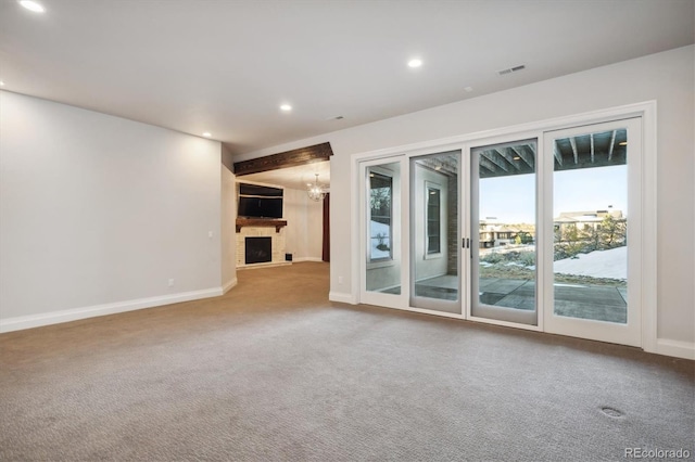 unfurnished living room with carpet flooring and an inviting chandelier