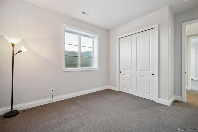 unfurnished bedroom featuring carpet floors and a closet